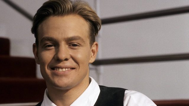 Jason Donovan's younger self grinning